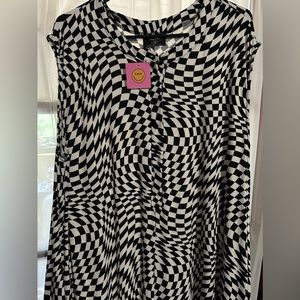 Dressed in Lala ultra oversized psychedelic checkered print jumpsuit.